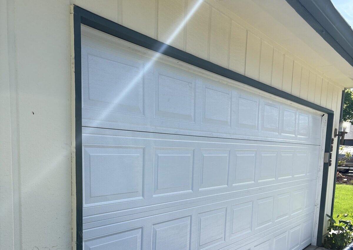 A fresh white garage door professionally installed by UP & FIX